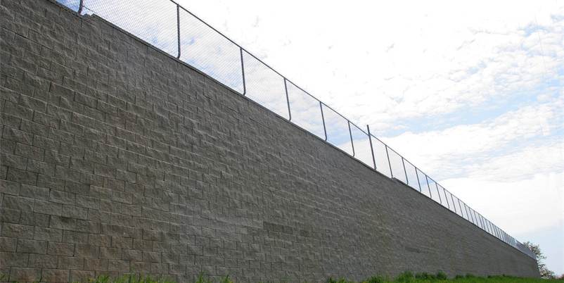 tall retaining wall with fence