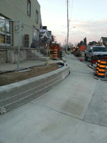 construction of retaining wall along sidewalk