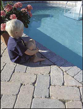 tiled backyard with pool and boy