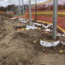 posts placed in the ground with concrete silos
