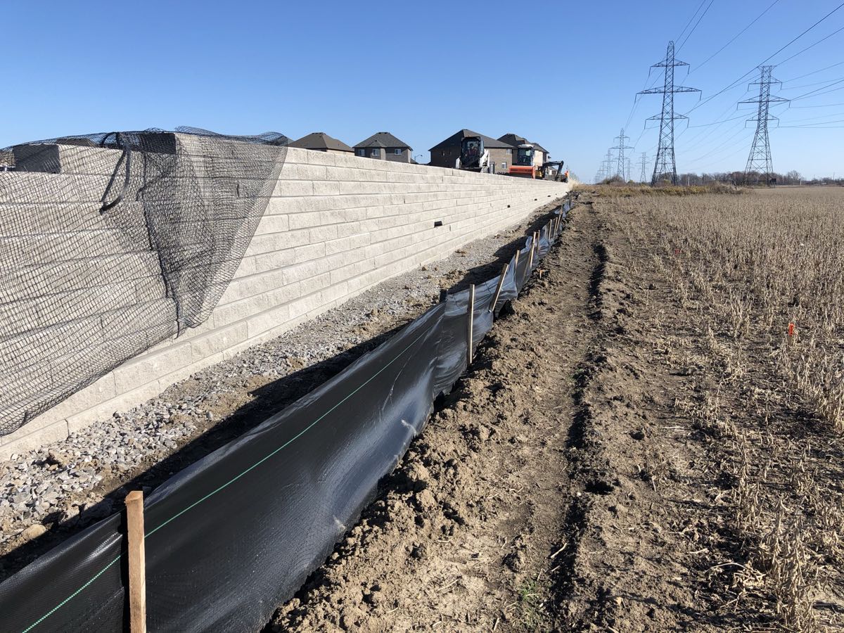 Precast retaining wall along farmers field and subdivision