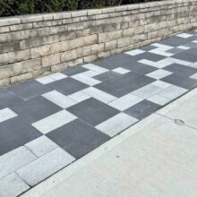tiled path outdoors with retaining wall
