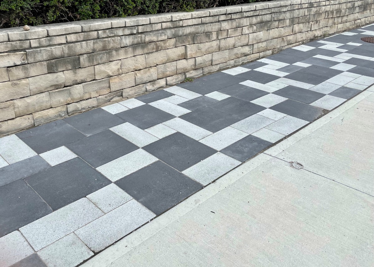 tiled path outdoors with retaining wall