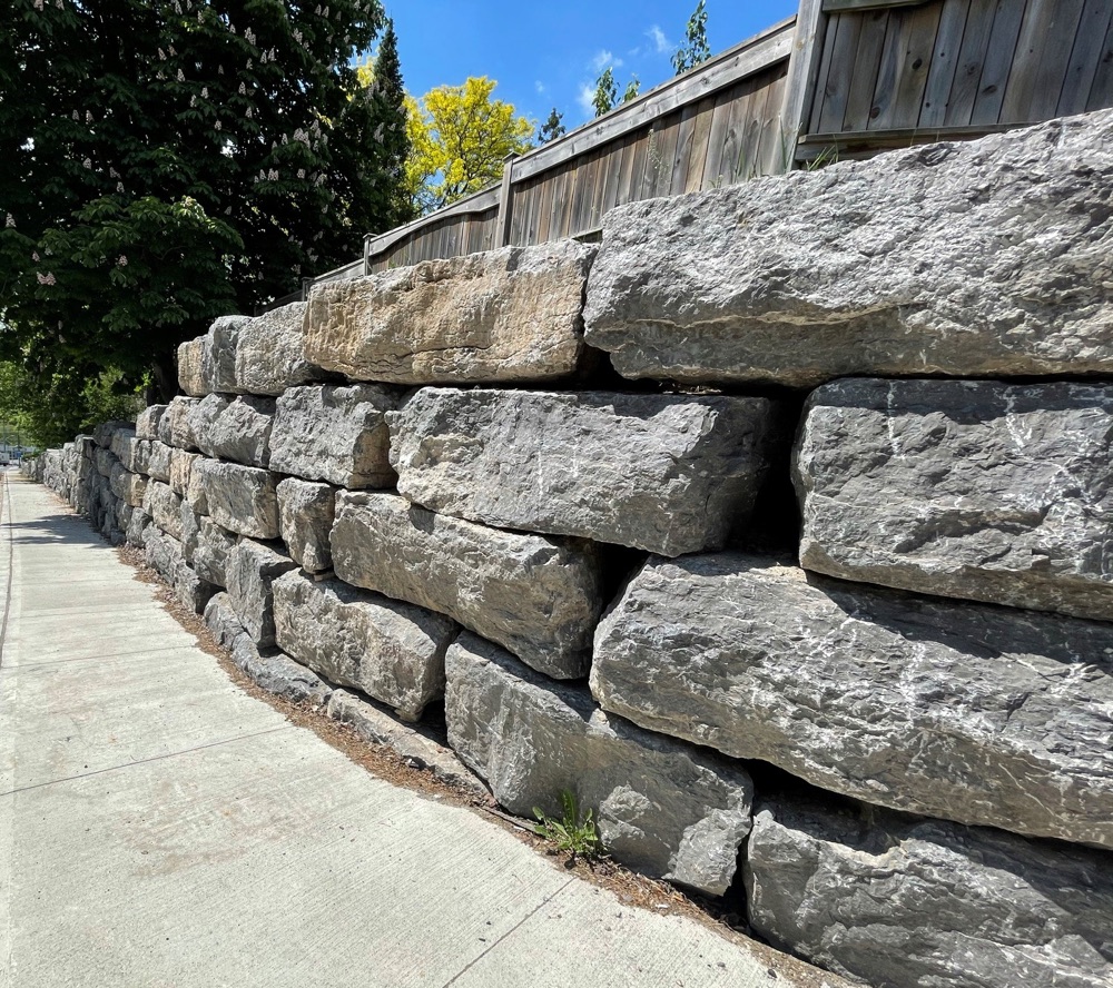 large stone retaining wall along sidewalk in Cambridge